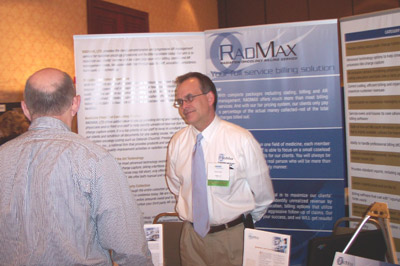 Exhibitor Kevin Ewalt (right), of Radmax, Ltd., speaks with attendees 