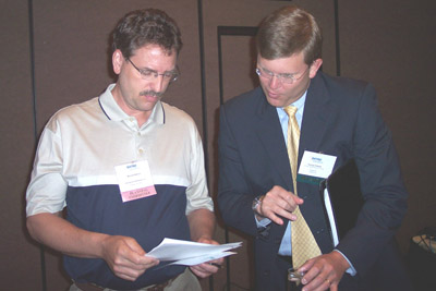 Attendee Russ Onken (left) talks with Presenter George Edlund (right) of Capgemini