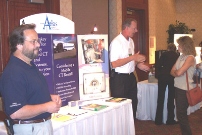 Exhibitors (left to right) Rich Scholz and Ron Brewer, Atlas Medical Technologies, talk with attendees 