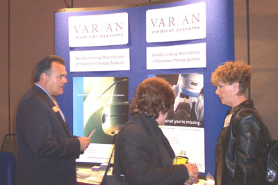 Exhibitor Glenn Barrow of Varian speaks with attendees 