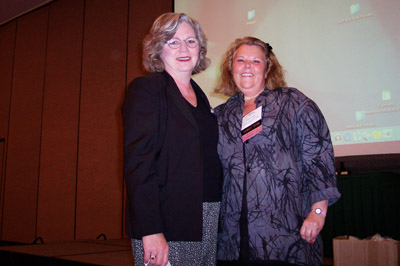 Jane Gonter (left) receives door prize from Marcia Phillips (right)