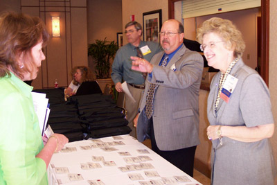 Board members (right to left) Darlene Johnson and Mickey Lowery chat with attendee 