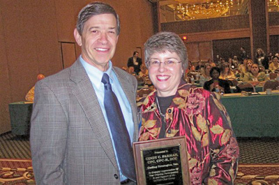 (L to R) Director Bud Baker, award recipient Cindy Parman, Coding Strategies